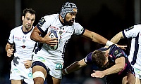 Clermont Auvergne's Fritz Lee is tackled by Exeter's Ollie Devoto