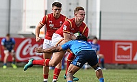 Wales full-back Phil Jones tries to burst through an Italian tackle in their seventh place play-off at Avchala Stadium
