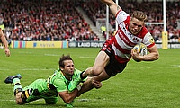 Gloucester's Jason Woodward beats the tackle of Northampton's Cobus Reinach to touch down
