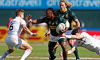 South Africa's Branco cu Preez fends off the England defence on day two of the Emirates Airline Dubai Rugby Sevens 2018
