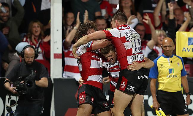 Jason Woodward (centre) is mobbed by his Gloucester team-mates after scoring the winning try