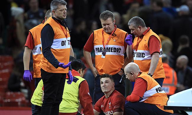 Jonathan Davies receives treatment after the tackle from Marika Koroibete