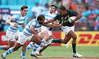 South Africa's Justin Geduld fends off the Argentina defense on day one of the HSBC World Rugby Sevens Series in Sydney
