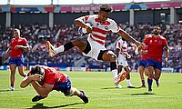 Kotaro Matsushima of Japan jumps over the tackle of Clemente Saavedra of Chile