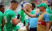 Johnny Sexton of Ireland is sprayed with water by a member of medical staff during the game against Romania