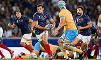 Arthur Vincent of France runs with the ball whilst under pressure from Felipe Aliaga of Uruguay during the Rugby World Cup