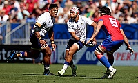 Christian Leali'ifano of Samoa runs with the ball whilst under pressure from Santiago Pedrero of Chile