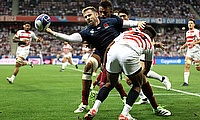 Elliot Daly of England is tackled by Kotaro Matsushima of Japan