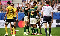 Grant Williams of South Africa celebrates with Damian Willemse and Canan Moodie of South Africa after scoring his team's seventh try during the game a