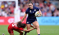 Francesca McGhie of Scotland breaks away with the ball as she is tackled by Nel Metcalfe of Wales during the Women's Rugby World Cup