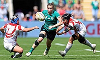 Eve Higgins of Ireland runs with the ball whilst under pressure from Sachiko Kato and Yuna Sato of Japan
