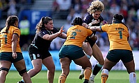 Ellie Kildunne of England is tackled by Adiana Talakai (L) and Lydia Kavoa of Australia