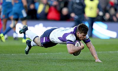 Huw Jones dives over at BT Murrayfield against France