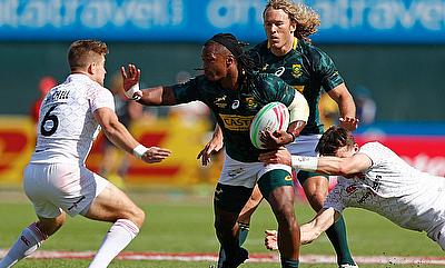 South Africa's Branco cu Preez fends off the England defence on day two of the Emirates Airline Dubai Rugby Sevens 2018