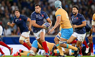 Arthur Vincent of France runs with the ball whilst under pressure from Felipe Aliaga of Uruguay during the Rugby World Cup