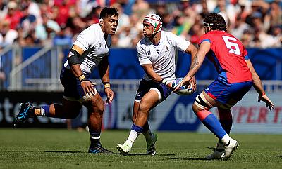 Christian Leali'ifano of Samoa runs with the ball whilst under pressure from Santiago Pedrero of Chile