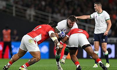 Andrew Porter of Ireland is tackled by Ben Tameifuna and Paula Ngauamo of Tonga