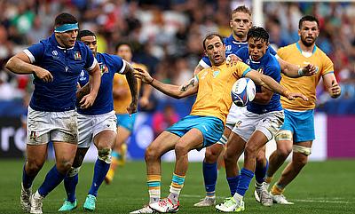 Gaston Mieres of Uruguay is tackled by Ange Capuozzo of Italy