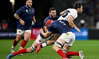 Andre Van der Bergh of Namibia is tackled by Charles Ollivon and Thibaud Flament of France