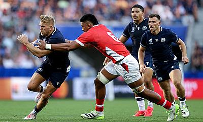 Chris Harris of Scotland is tackled by Tanginoa Halaifonua of Tonga