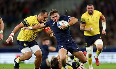 Ollie Smith of Scotland evades Alexandru Savin of Romania during the Rugby World Cup game