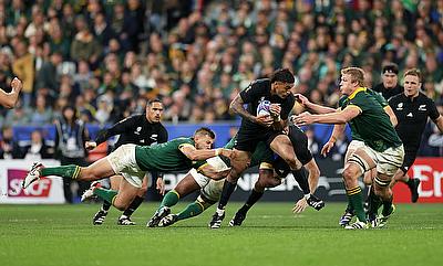 Rieko Ioane of New Zealand runs with the ball whilst under pressure from Pieter-Steph Du Toit of South Africa during the Rugby World Cup Final match