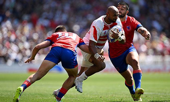 Semisi Masirewa of Japan is tackled by Rodrigo Fernandez and Franco Velarde of Chile in the game in Toulouse