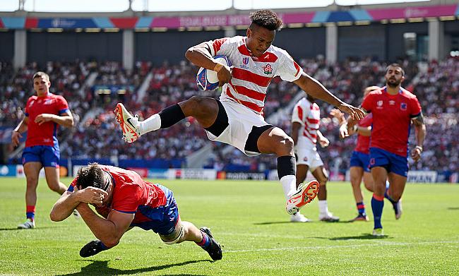 Kotaro Matsushima of Japan jumps over the tackle of Clemente Saavedra of Chile