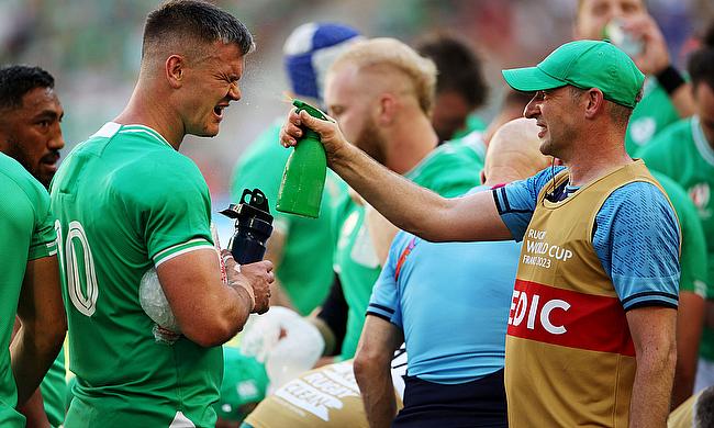 Johnny Sexton of Ireland is sprayed with water by a member of medical staff during the game against Romania