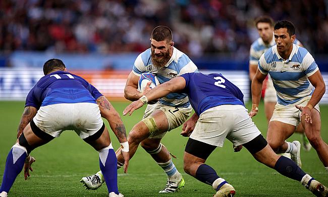 Marcos Kremer of Argentina takes on Ben Lam and Seilala Lam of Samoa during the Rugby World Cup game at Stade Geoffroy-Guichard