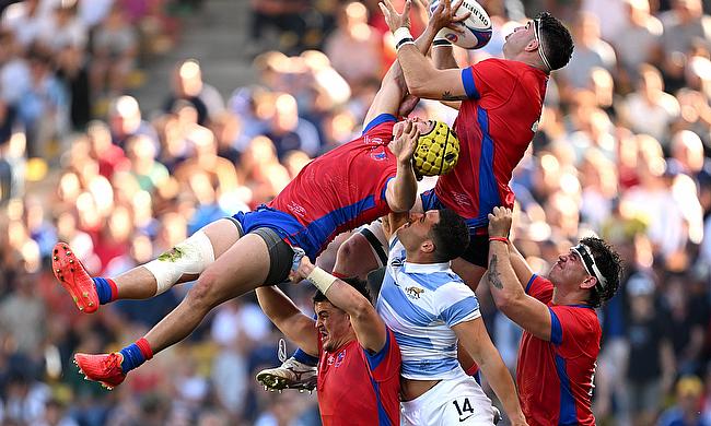 Matias Garafulic and Raimundo Martinez of Chile contends for the aerial ball with Rodrigo Isgro of Argentina